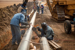 construction workers install a pipeline 