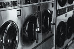 closeup black and white view of front loading washing machines